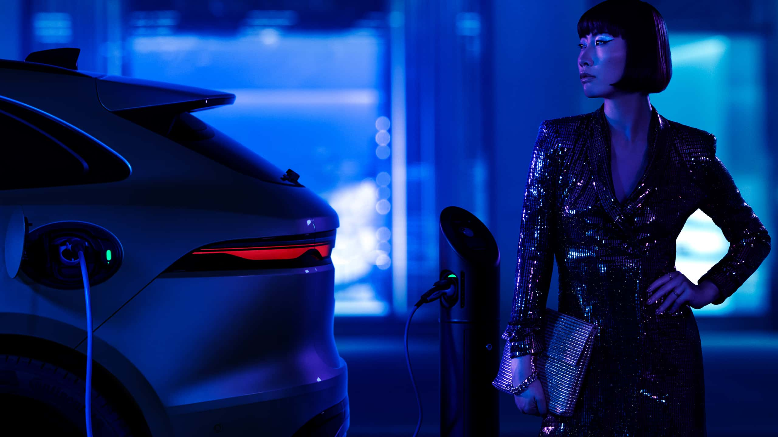 Unidentified beautiful young model standing beside Jaguar F-Pace car